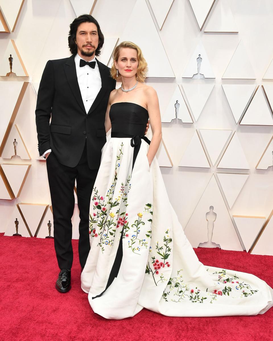 Adam Driver is wearing a Burberry tuxedo while his wife, Joanne Tucker, chose a vintage Oscar de la Renta gown. <em>[Photo: Getty]</em>