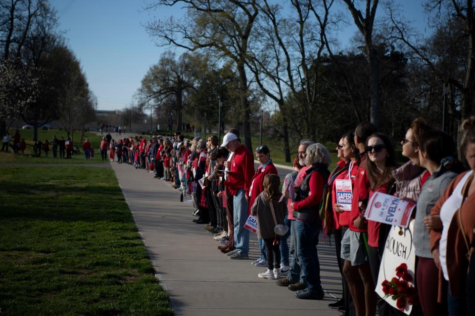 Participants stand together during the Linking Arms for Change, event at Centennial Park in Nashville, Tenn., Wednesday, March 27, 2024. The event was in remembrance of the Covenant school shooting where 6 people- three children and three adults- were killed last year.