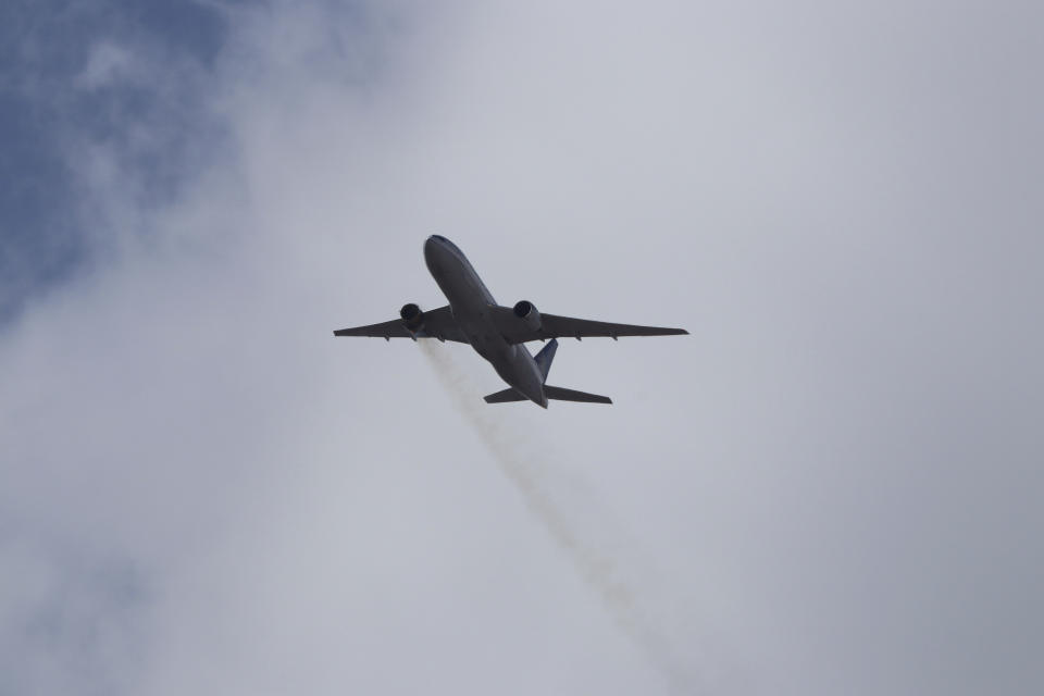 This Saturday, Feb. 20, 2021 photo provided by Hayden Smith shows United Airlines Flight 328 approaching Denver International Airport, after experiencing "a right-engine failure" shortly after takeoff from Denver. Federal regulators are investigating what caused a catastrophic engine failure on the plane that rained debris on Denver suburbs as the aircraft made an emergency landing. Authorities said nobody aboard or on the ground was hurt despite large pieces of the engine casing that narrowly missed homes below. (Hayden Smith via AP)