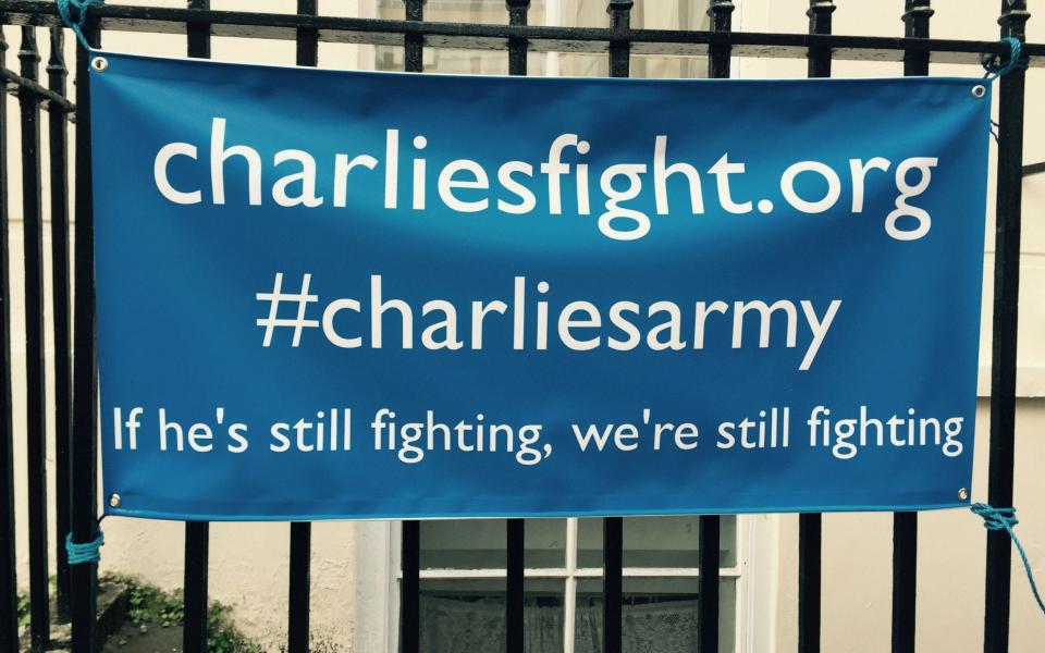 A banner hung on railings outside Great Ormond Street Hospital for Children in London - Credit: PA