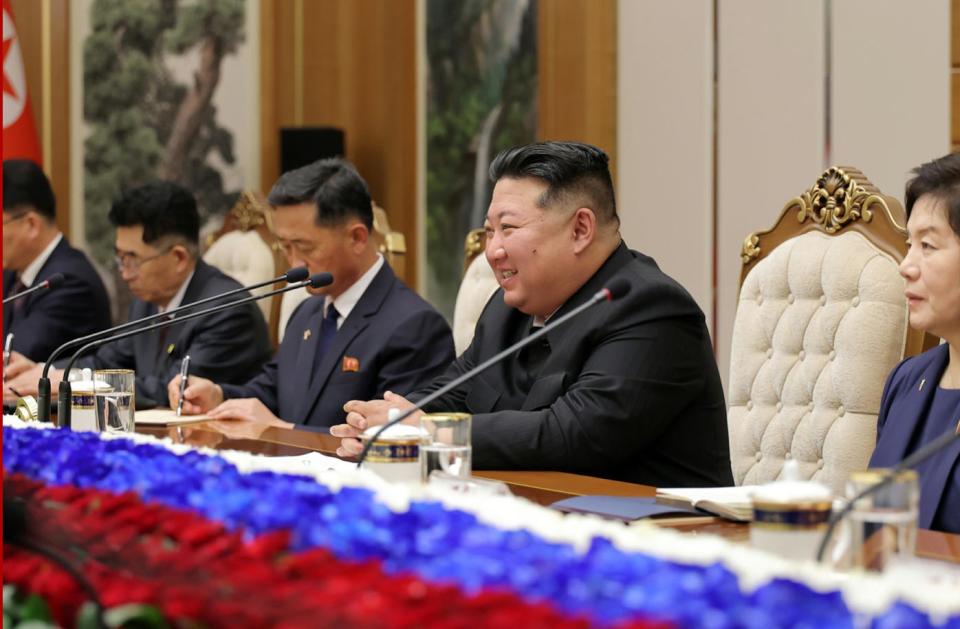 Kim Jong Un smiles as he attends negotiations with Vladimir Putin.