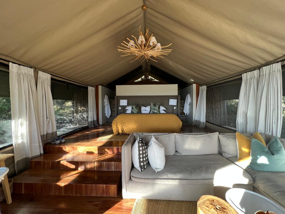 Inside Tassa lodge tent - fancy light, couch, bed 