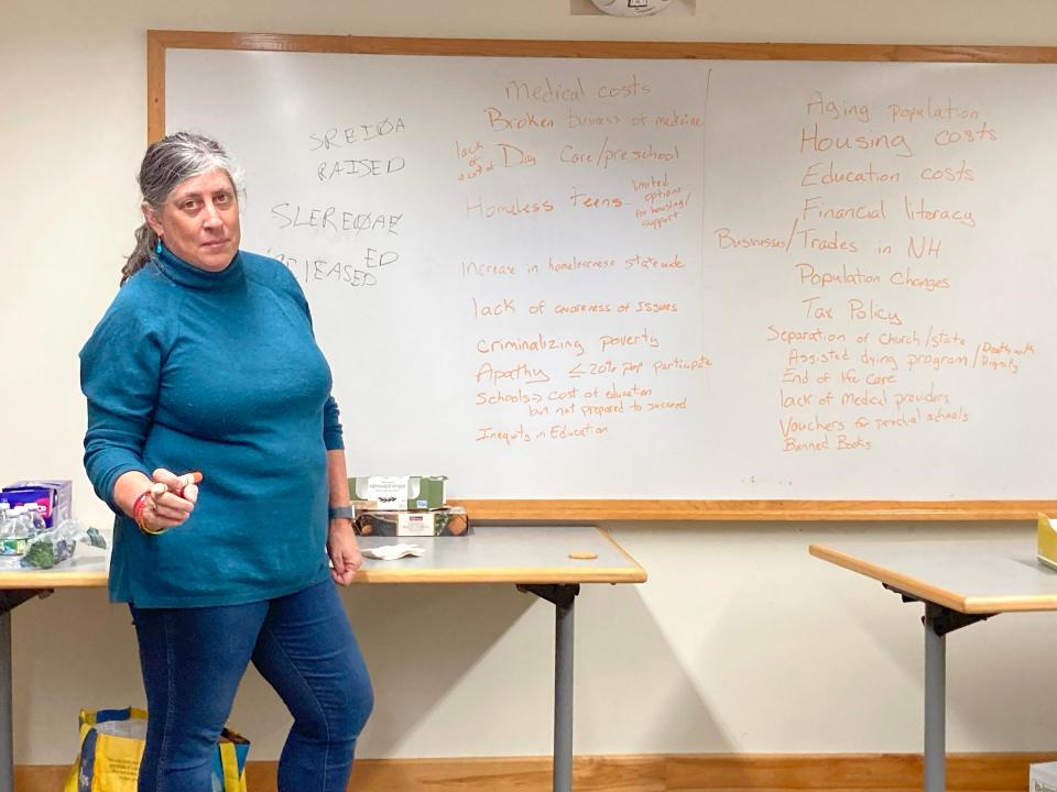 Lorin Selig from Durham (State Rep). takes notes on whiteboard during a community conversation.