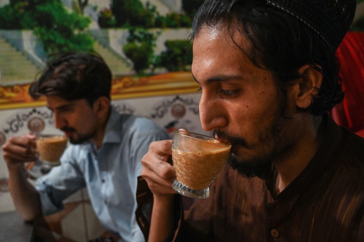 Men drink a tea at a restaurant in Islamabad, Pakistan, June 15, 2022. / Credit: AAMIR QURESHI/AFP/Getty