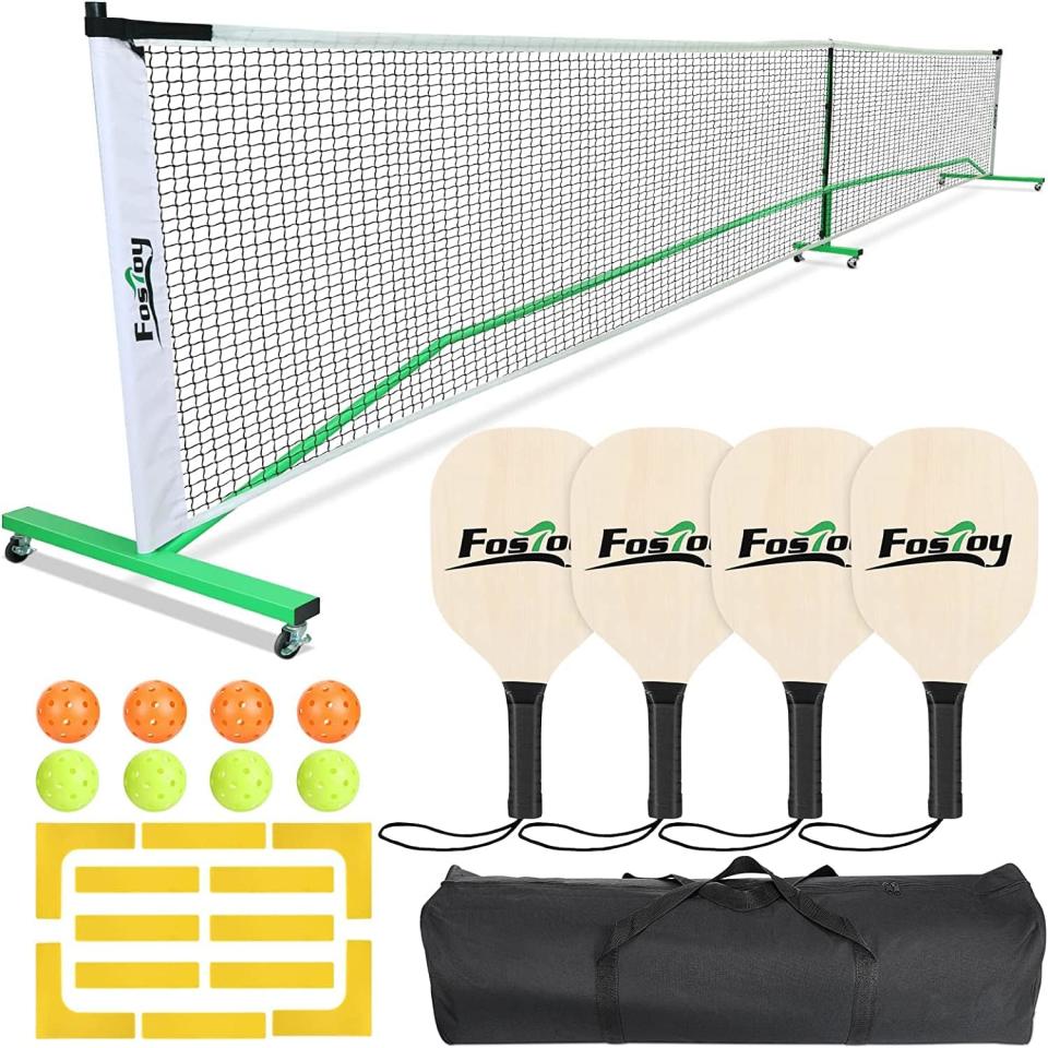 white and green pickleball net, four wood and black paddles, eight plastic balls and a black carrying bag