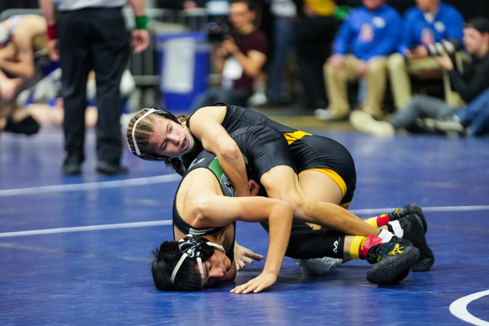 Sigourney-Keota’s Reanah Utterback, top, wrestles Clayton Ridge’s Erik Flores at 106 pounds during the second round of the Class 1A of the Iowa high school state wrestling tournament at Wells Fargo Arena in Des Moines on Wednesday, Feb. 15, 2023.