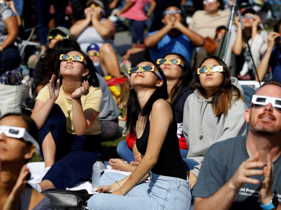 People watch the solar eclipse on the lawn of Griffith Observatory in Los Angeles, California, U.S., August 21, 2017.