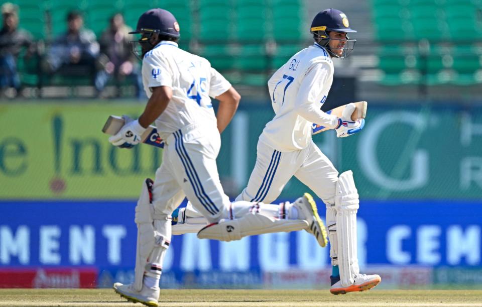 <span>India's Shubman Gill (right) and captain Rohit Sharma, both on their way to centuries, run between the wickets on the second day of the fifth Test.</span><span>Photograph: Sajjad Hussain/AFP/Getty Images</span>