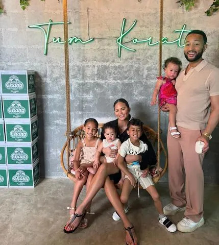 <p>Chrissy Teigen/Instagram</p> Chrissy Teigen and John Legend in Korat, Thailand with their four children