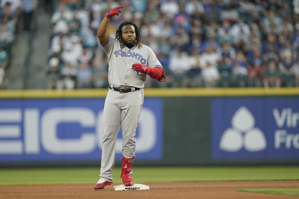 Toronto Blue Jays' Vladimir Guerrero Jr. gestures from second base after he lost his helmet running on a double during the fifth inning of the team's baseball game against the Seattle Mariners, Friday, July 8, 2022, in Seattle. (AP Photo/Ted S. Warren)