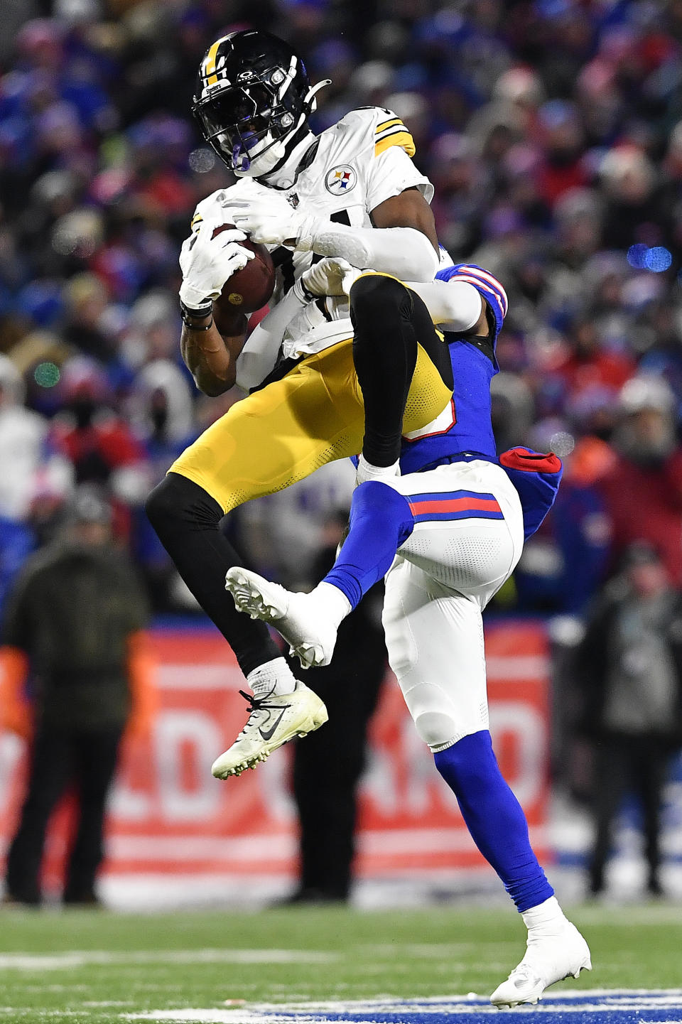 Pittsburgh Steelers wide receiver George Pickens (14) makes a catch against the Buffalo Bills during the third quarter of an NFL wild-card playoff football game, Monday, Jan. 15, 2024, in Buffalo, N.Y. (AP Photo/Adrian Kraus)