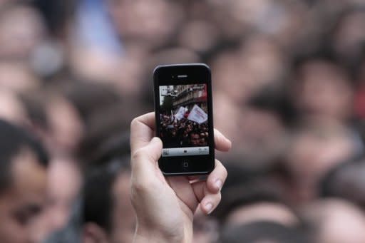 Photo illustration shows a woman taking a photo with a smartphone. Micro films add another dimension to a Chinese film industry that last year saw box office receipts total more than US$2 billion for the first time, making it the world's second largest behind North America