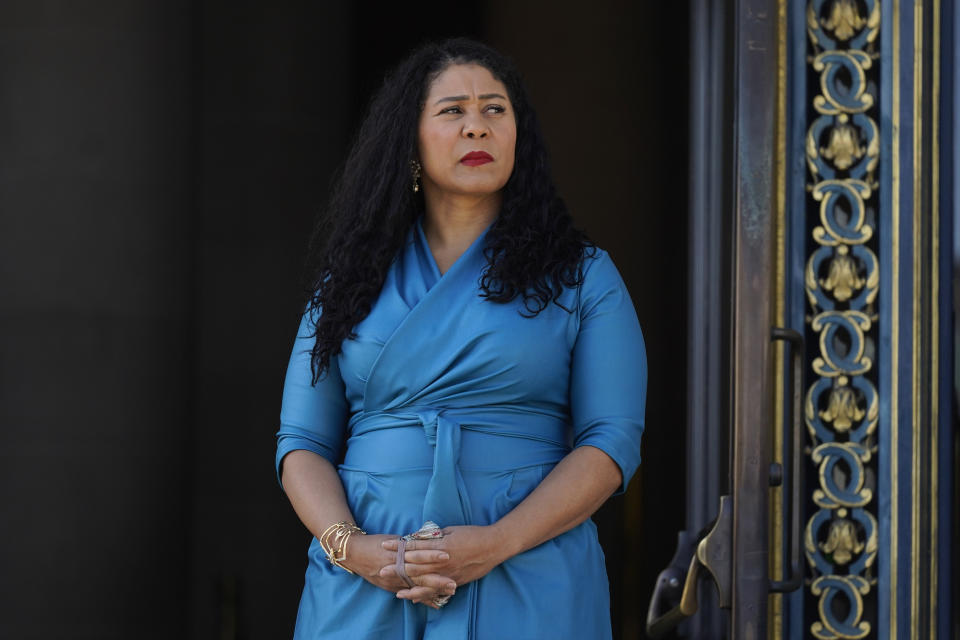 FILE - San Francisco Mayor London Breed listens during a briefing outside City Hall in San Francisco on Dec. 1, 2021. A fed-up Breed announced Tuesday, Dec. 14, 2021, San Francisco will dramatically crack down on open drug use and sales and illegal vending of stolen goods that's fueled smash and grab robberies. (AP Photo/Eric Risberg, File)