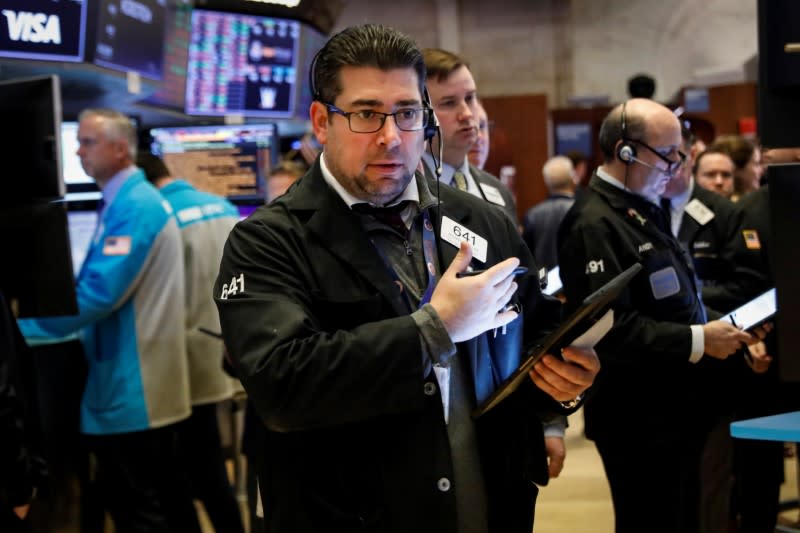 Traders work on the floor at the NYSE in New York