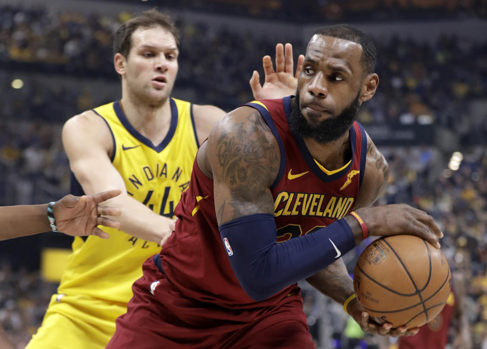 LeBron James, right, looks to pass as the Pacers’ Bojan Bogdanovic defends him during the first half Sunday. (AP)
