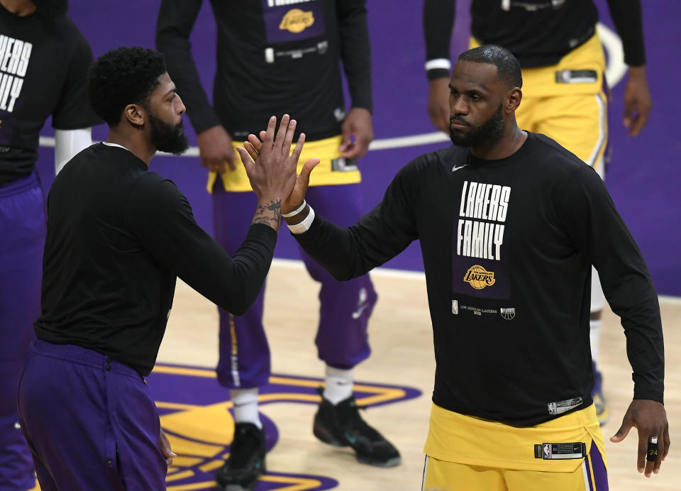 LeBron James #23 of the Los Angeles Lakers and Anthony Davis #3 high five before the game against the Phoenix Suns during game six of the Western Conference first round series at Staples Center on June 03, 2021 in Los Angeles, California. (Photo by Harry How/Getty Images) NOTE TO USER: User expressly acknowledges and agrees that, by downloading and or using this photograph, User is consenting to the terms and conditions of the Getty Images License Agreement.