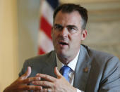 FILE - In this July 2, 2019 file photo, Oklahoma Governor Kevin Stitt is pictured during an interview in Oklahoma City. For the last 15 years, casino gambling has been a financial boon for Oklahoma and many of the Native American tribes located there. The tribes are now locked in a showdown with Oklahoma’s new Republican governor, Stitt, who has demanded a larger share of casino revenue for the state. (AP Photo/Sue Ogrocki, File)