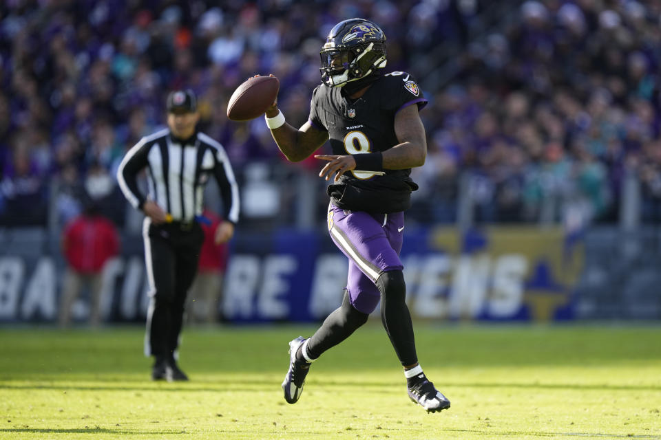 Baltimore Ravens quarterback Lamar Jackson (8) looks to pass as he scrambles against the Miami Dolphins during the first half of an NFL football game in Baltimore, Sunday, Dec. 31, 2023. (AP Photo/Matt Rourke)