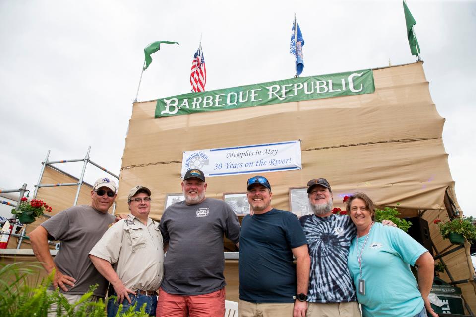 Barbeque Republic team members pose in front of their booth before the start of the Memphis in May World Championship Barbecue Cooking Contest at Tom Lee Park in Downtown Memphis on Wednesday, May 17, 2023.