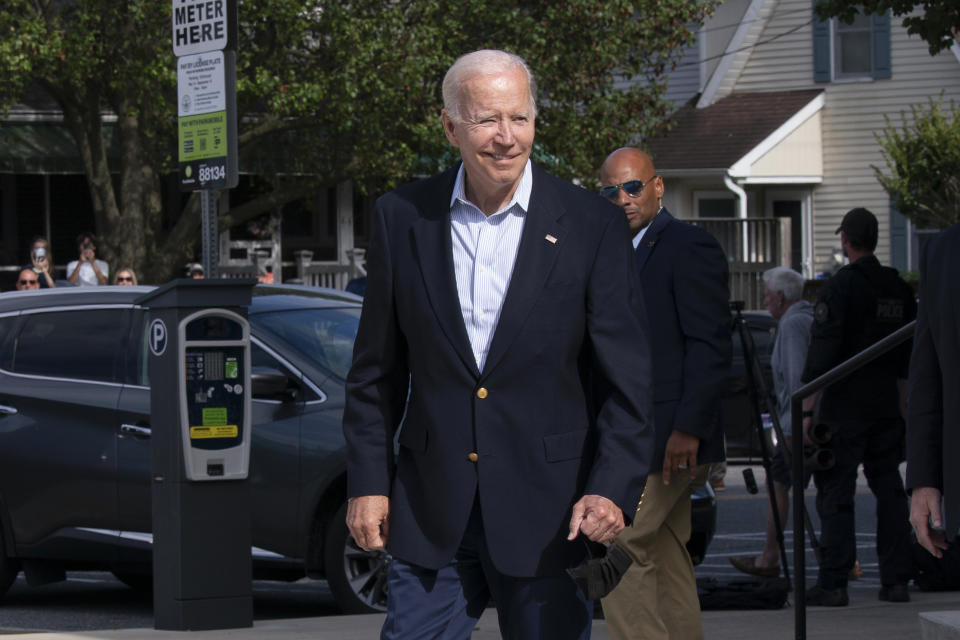 President Joe Biden reacts when asked how he was feeling as he leaves St. Edmund Roman Catholic Church in Rehoboth Beach, Del., after attending a Mass, Saturday, June 18, 2022. Bystanders cheered as he was asked how he was feeling. He smiled, and took three hops forward, making a jump-rope motion with his hands. (AP Photo/Manuel Balce Ceneta)