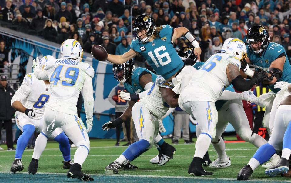 Jacksonville Jaguars quarterback Trevor Lawrence (16) scores a two-point conversion.