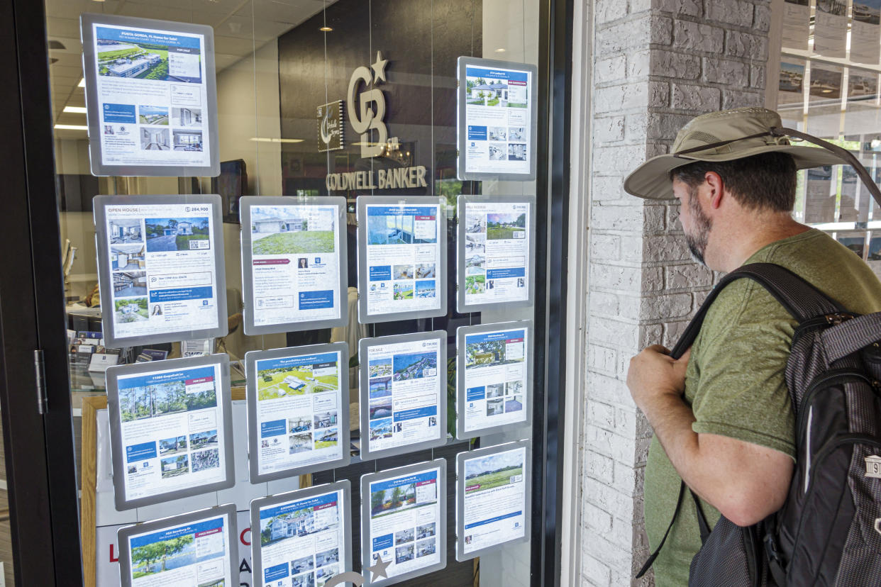 Punta Gorda, Florida, Coldwell Banker, real estate office, man looking at property listings and homes for sale. (Credit: Jeffrey Greenberg/Universal Images Group, Getty Images)
