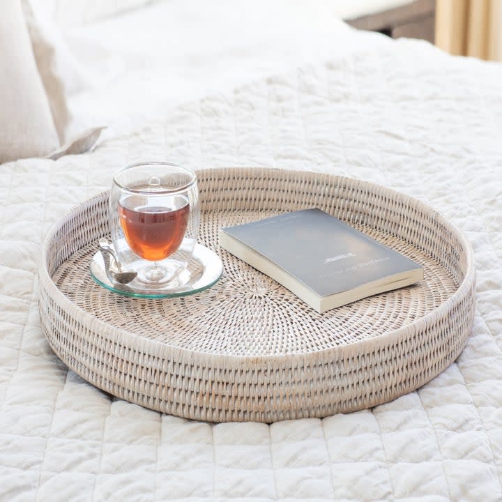 the circular rattan tray on a bed