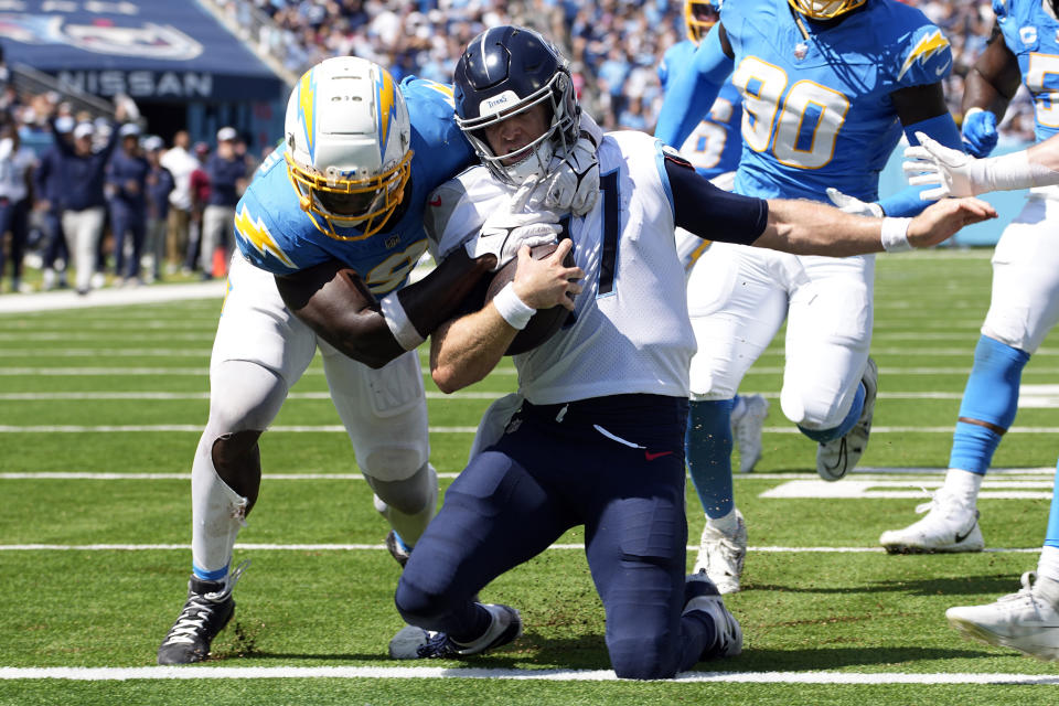 Tennessee Titans quarterback Ryan Tannehill (17) scores a touchdown past Los Angeles Chargers linebacker Kenneth Murray Jr., left, during the second half of an NFL football game Sunday, Sept. 17, 2023, in Nashville, Tenn. (AP Photo/George Walker IV)