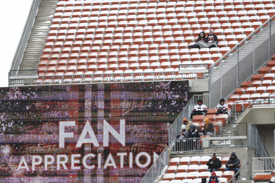 Football fans watch during the first half of an NFL football game between the Cleveland Browns and the New Orleans Saints, Saturday, Dec. 24, 2022, in Cleveland. (AP Photo/Ron Schwane)