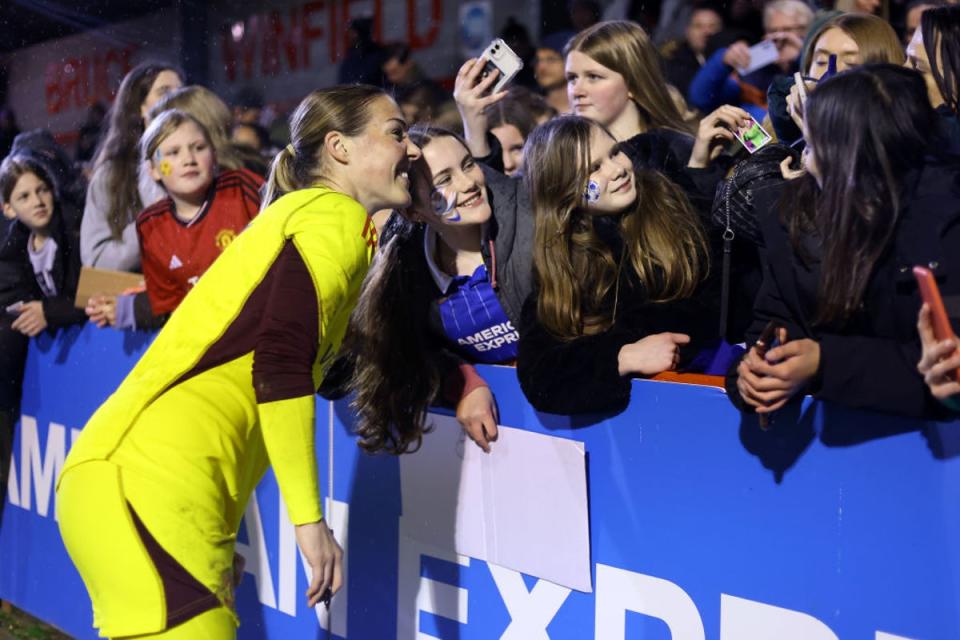 Mary Earps, who has since joined PSG, stops for a photo with a Manchester United fan (The FA via Getty Images)