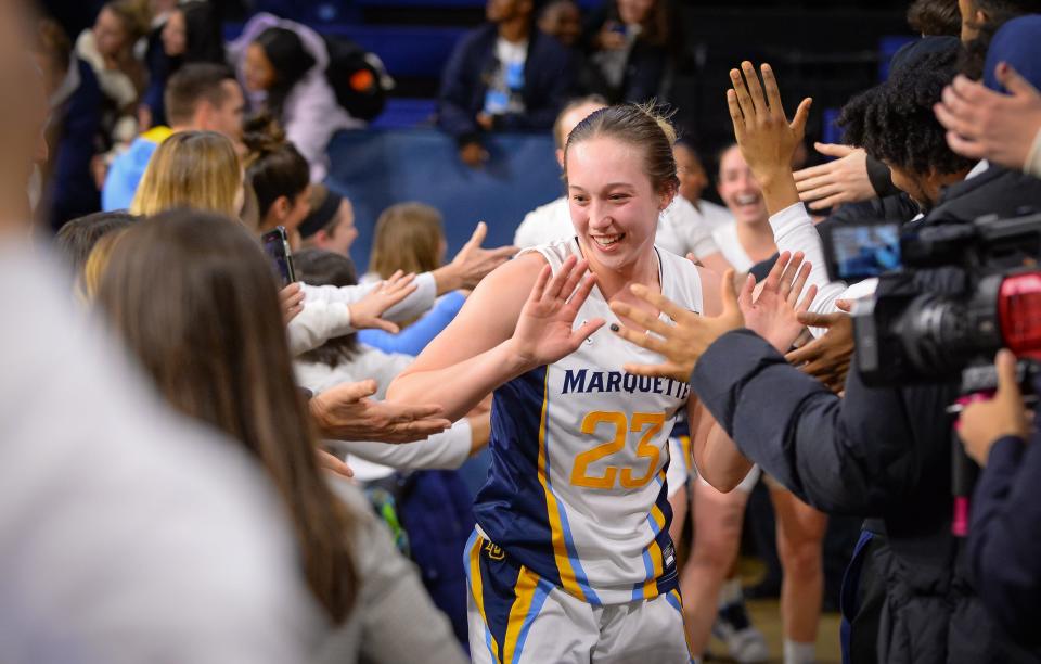 Marquette guard Jordan King high-five fans after a 59-52 victory over UConn on Wednesday night at the Al McGuire Center.