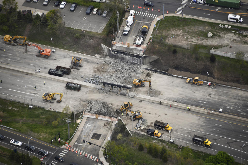 This aerial view shows demolition crews working to finish removing the Fairfield Avenue bridge over Interstate 95, Saturday, May 4, 2024 in Norwalk, Conn. Crews are expected to finish removing the bridge by Sunday morning, and road repairs will be made. The tanker truck burst into flames under the overpass after colliding with two other vehicles Thursday. The cause remains under investigation. (Kevin Coughlin / All Island Aerial via AP)