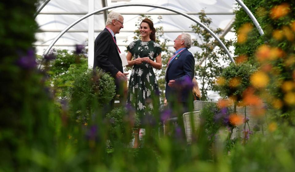 All smiles: Kate chats to exhibitors (REUTERS)