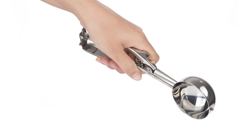 person holding ice cream scoop