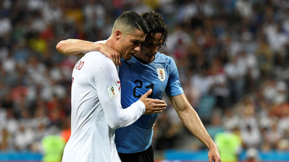 Ronaldo helps the injured Cavani from the field. Pic: Getty