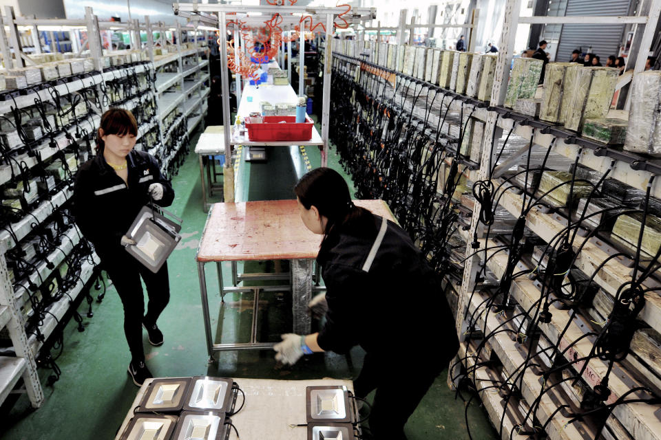 In this Saturday, March 30, 2019, photo, workers transfer LED lights components at a factory in Yushan county in central China's Jiangxi province. Chinese exporters of all sorts of products, from power adapters and computers to vacuum cleaners, are anxiously hoping trade talks in Washington this week will yield a deal that might stave off higher U.S. tariffs on imports from China. (Chinatopix via AP)