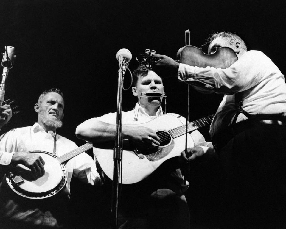 FILE - In this July 24, 1963 file photo, Doc Watson, center, performs with the Watson Family on the opening night of the Newport Folk Festival in Newport, R.I. Doc Watson, the Grammy-award winning folk musician whose lightning-fast style of flatpicking influenced guitarists around the world for more than a half-century, died Tuesday, May 29, 2012 at a hospital in Winston-Salem, according to a hospital spokeswoman and his management company. He was 89. (AP File Photo)