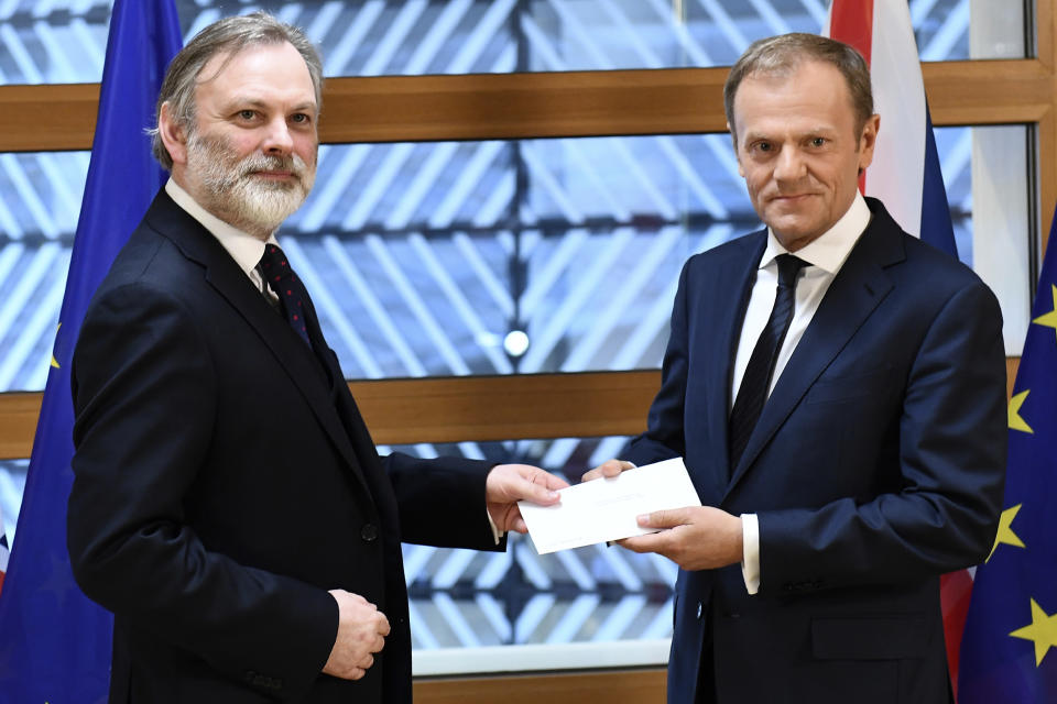 FILE - In this Wednesday, March 29, 2017 file photo, EU Council President Donald Tusk, right, receives British Prime Minister Theresa May's formal notice to leave the bloc, under Article 50 of the EU's Lisbon Treaty, from UK Permanent Representative to the EU Tim Barrow in Brussels. Britain and the European Union have struck a provisional free-trade agreement that should avert New Year chaos for cross-border traders and bring a measure of certainty for businesses after years of Brexit turmoil. (Emmanuel Dunand, Pool via AP, File)