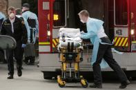 A medic prepares a stretcher to transfer a patient into an ambulance at the Life Care Center of Kirkland, the long-term care facility linked to several confirmed coronavirus cases in the state, in Kirkland
