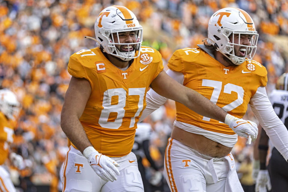 Tennessee quarterback Joe Milton III (7) celebrates a touchdown with offensive lineman Addison Nichols (72) during the first half of an NCAA college football game against Vanderbilt Saturday, Nov. 25, 2023, in Knoxville, Tenn. (AP Photo/Wade Payne)