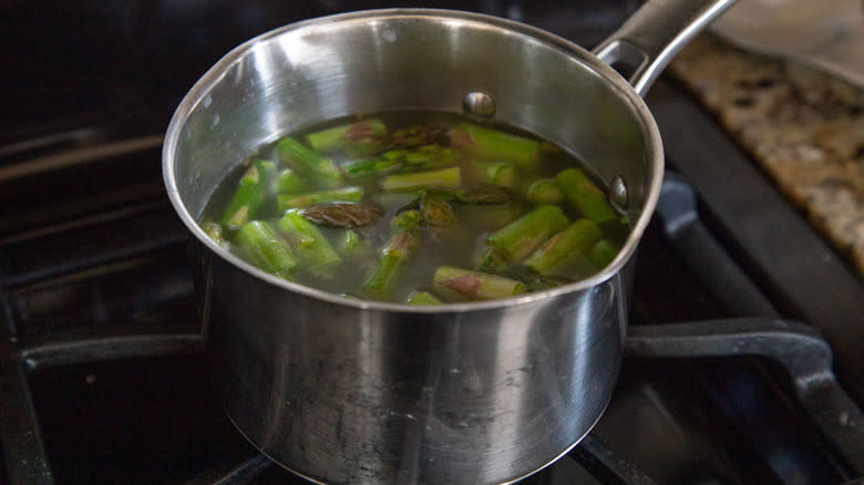 chopped asparagus in saucepan