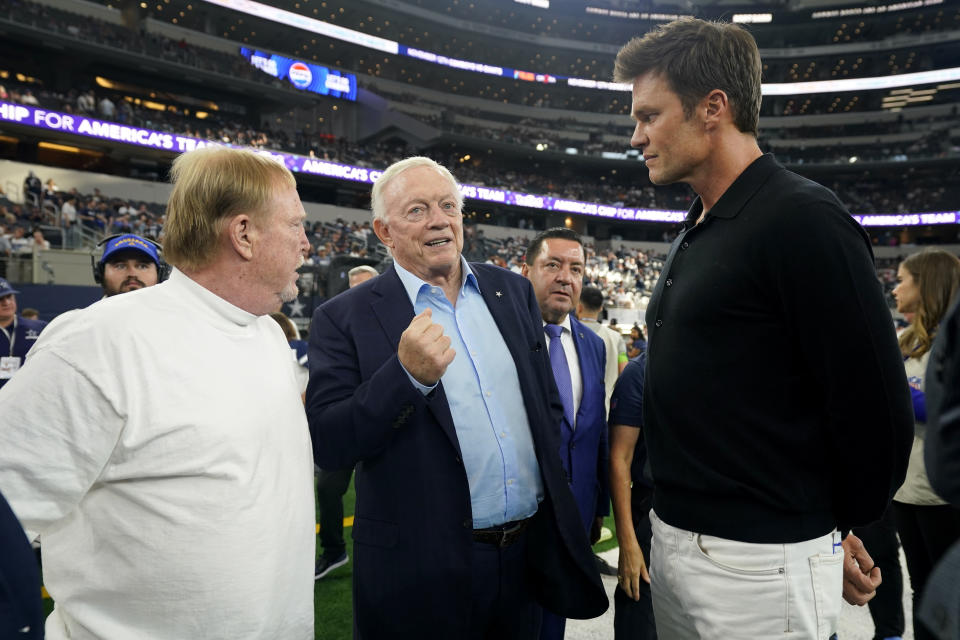 Las Vegas Raiders owner Mark Davis, left, Dallas Cowboys owner Jerry Jones, center, and former player Tom Brady, right, talk on the sideline before a preseason NFL football game between the two teams in Arlington, Texas, Saturday, Aug. 26, 2023. (AP Photo/Sam Hodde)