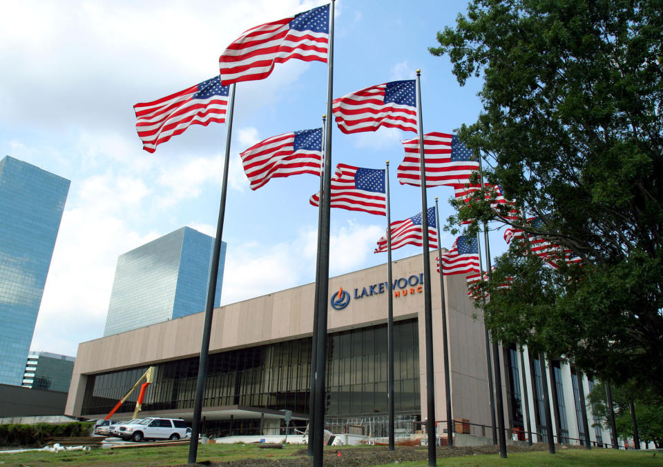 FILE - Flags fly in front of the Lakewood Church in this June 28, 2005 file photo in Houston. Authorities are investigating after $600,000 in checks and cash was stolen from a safe at Pastor Joel Osteen's Houston megachurch, which has one of the largest congregations in the country. Police spokesman Kese Smith said Tuesday March 11, 2014 $200,000 in cash and $400,000 in checks were stolen from a safe sometime between 2:30 p.m. Sunday and 8:30 a.m. Monday. (AP Photo/Pat Sullivan, File)