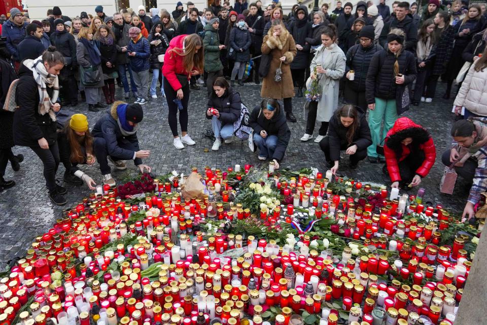 Mourners lay candle lights outside the headquarters of Charles University for victims of mass shooting in Prague, Czech Republic, Friday, Dec. 22, 2023. A lone gunman opened fire at a university on Thursday, killing more than a dozen people and injuring scores of people. (AP Photo/Petr David Josek)