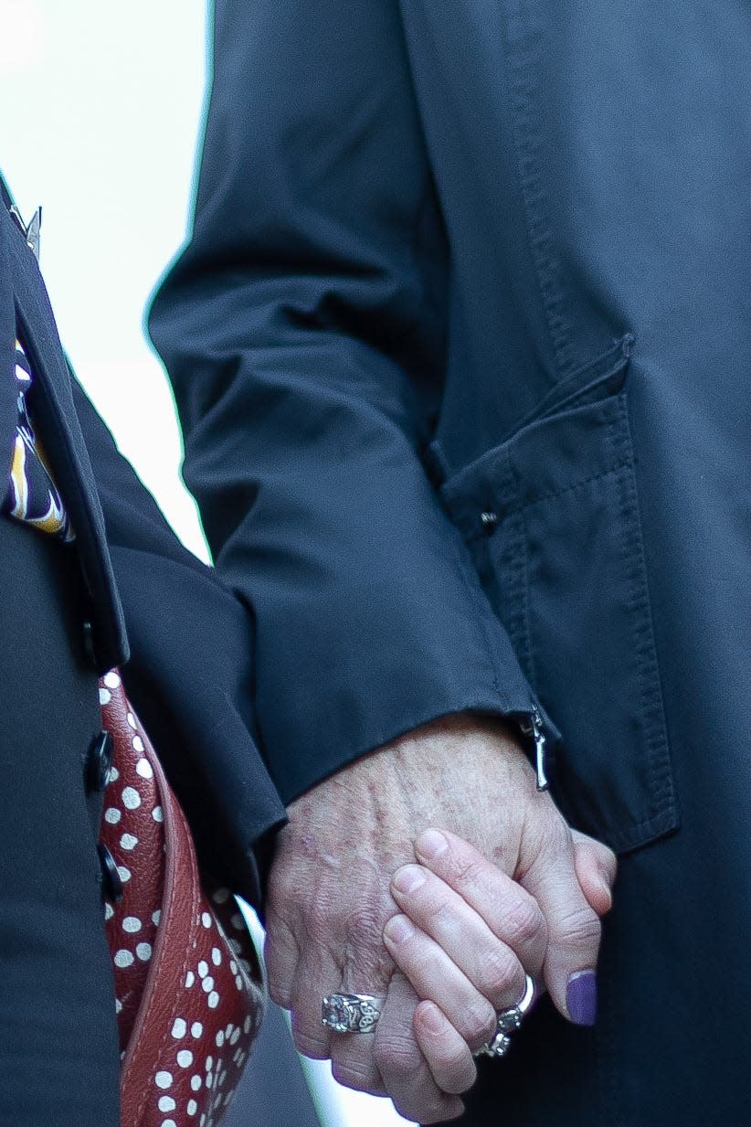 Kelsie Schelling's mother, Laura Saxton, holds the hand of Michelle Chostner as Schelling's mother addressed reporters following Lucas's verdict and sentencing in 2021.