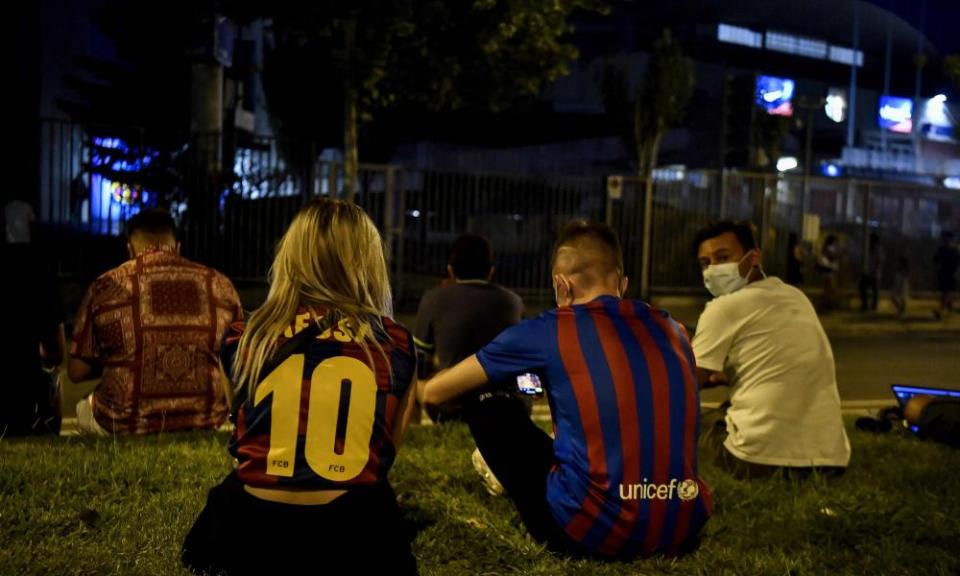 Barcelona fans gather in front of the Camp Nou on Thursday night after hearing that Lionel Messi was leaving the club.