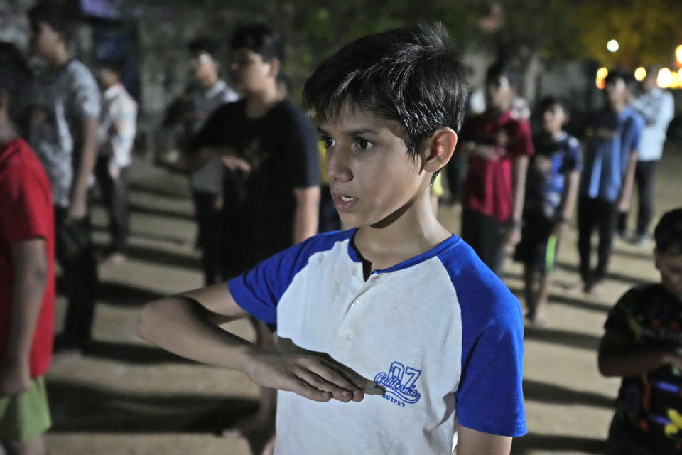 Youth and children participate in Hindu nationalist organisation Rashtriya Swayamsevak Sangh (RSS)'s shakha in Ahmedabad, India, April 8, 2024. Shakhas, or local units, induct boys by combining religious education with self-defense skills and games. (AP Photo/Ajit Solanki)