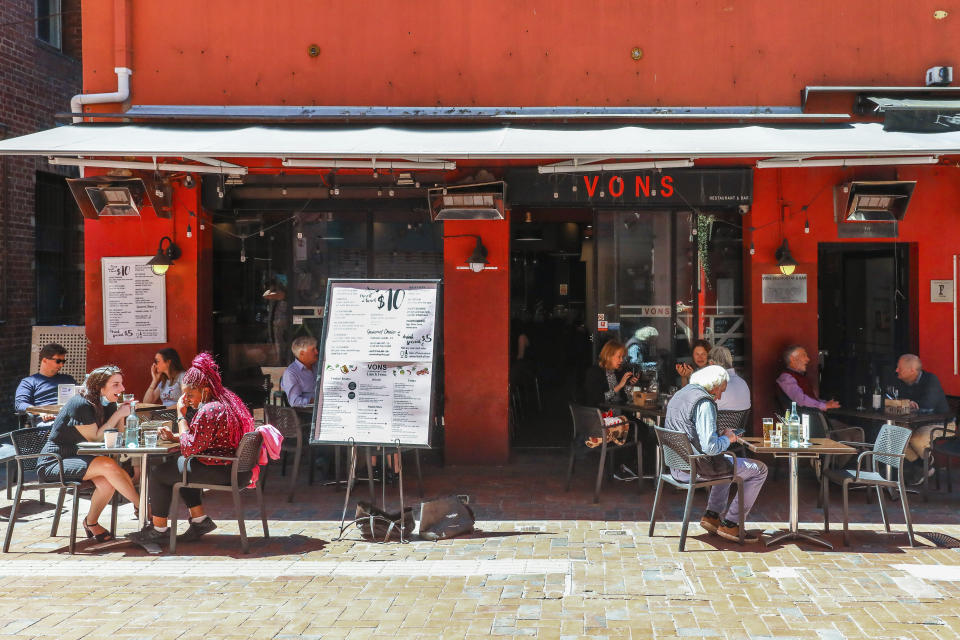 Outdoor diners are seen dining outdoors in a laneway in Melbourne, Australia, Wednesday, Oct. 28, 2020. In Melbourne, Australia's former coronavirus hot spot, restaurants, cafes and bars were allowed to open and outdoor contact sports can resume Wednesday, emerging from a lockdown due to the coronavirus outbreak. (AP Photo/Asanka Brendon Ratnayake)