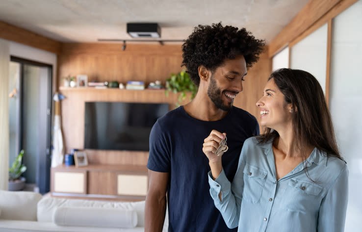 A couple celebrating the purchase of a home after having negotiated a deal.