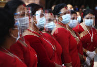 Nepalese devotees wearing protective gear as a precautionary measure against the coronavirus participate on Pachali Bhairav festival in Kathmandu, Nepal, Wednesday, Oct. 21, 2020. The festival which is usually celebrated in the night time during Dashain festival was celebrated during the day because of the pandemic. (AP Photo/Niranjan Shrestha)